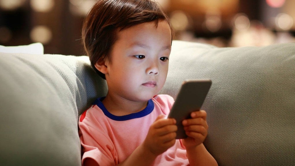 Little Boy Looking At Phone On Couch 1024X576 1515610949