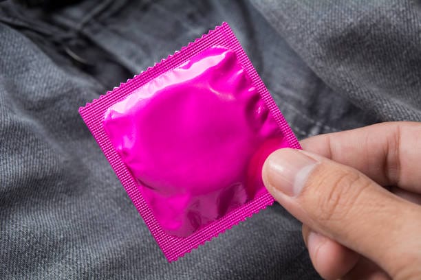 2157249 Hand Holding A Pink Condom