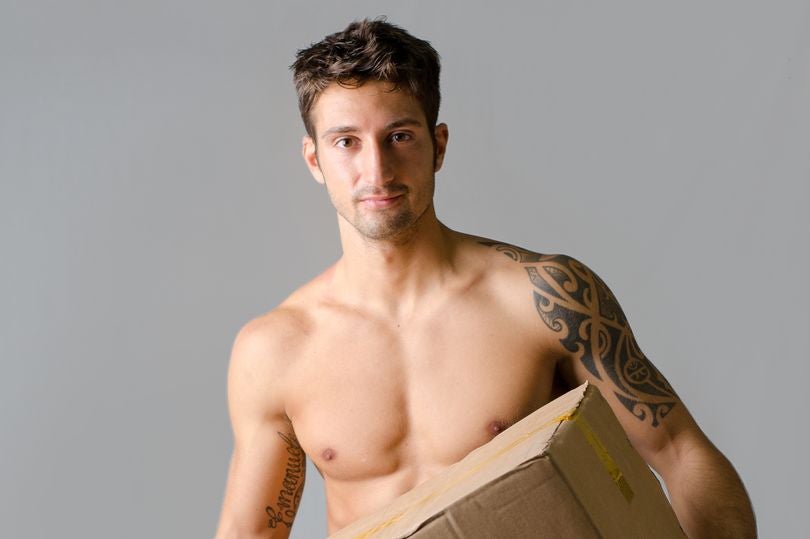 2 Handsome athletic shirtless young man carrying big cardboard