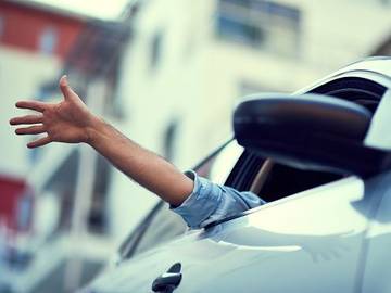 person waving from car window 7015