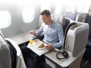 Man Enoying Food In Mas Malaysia Airlines Airplane