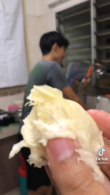 SS2 Holding a piece of durian