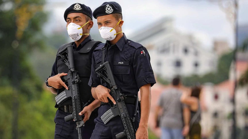 2 Police officers holding gun in Malaysia