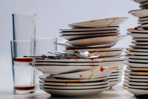 Dirty piles of dishes and cups