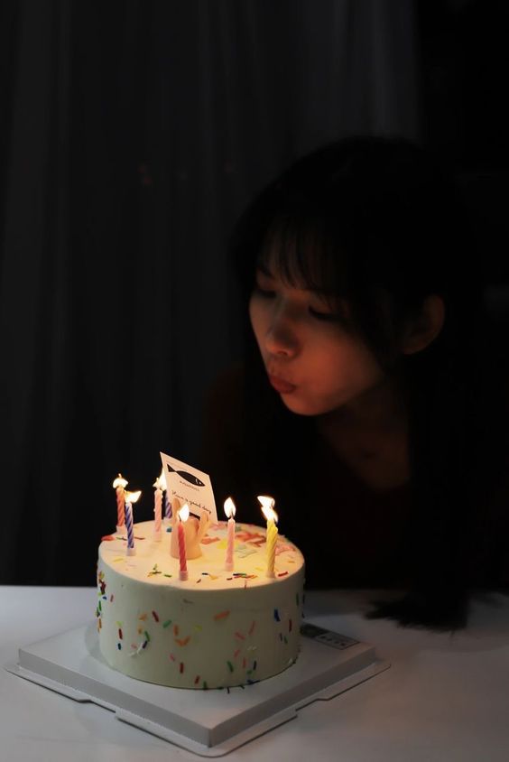 Girl Celebrating Birthday With A Cake In The Dark