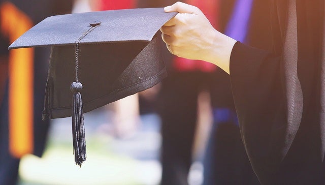 Holding Graduation Hat