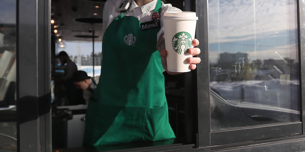 Starbucks drive thru barista handing coffee 2