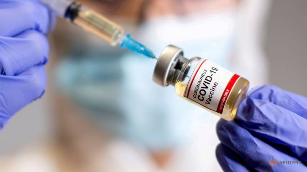 medical syringe and a small bottle labelled coronavirus covid 19 vaccine