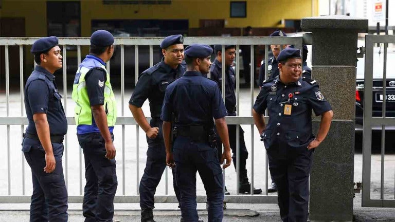 Pdrm Officers Standing In Front Of Gate