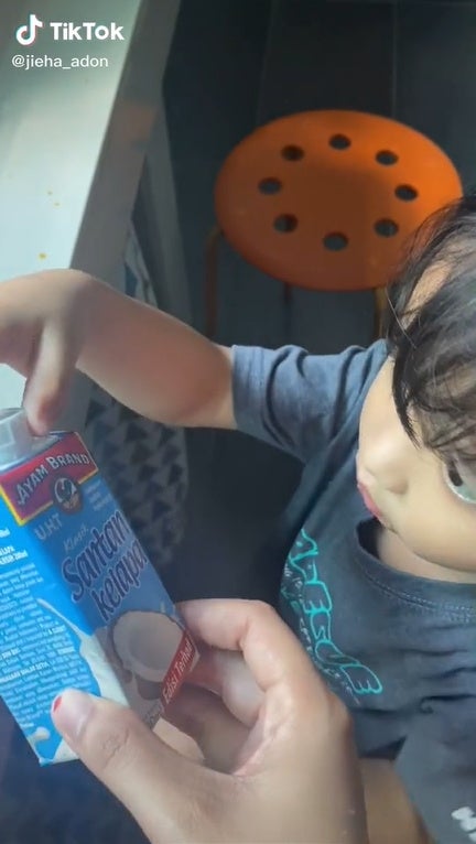 SS 2 kid boy drinking coconut milk