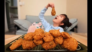 girl eating fried chicken