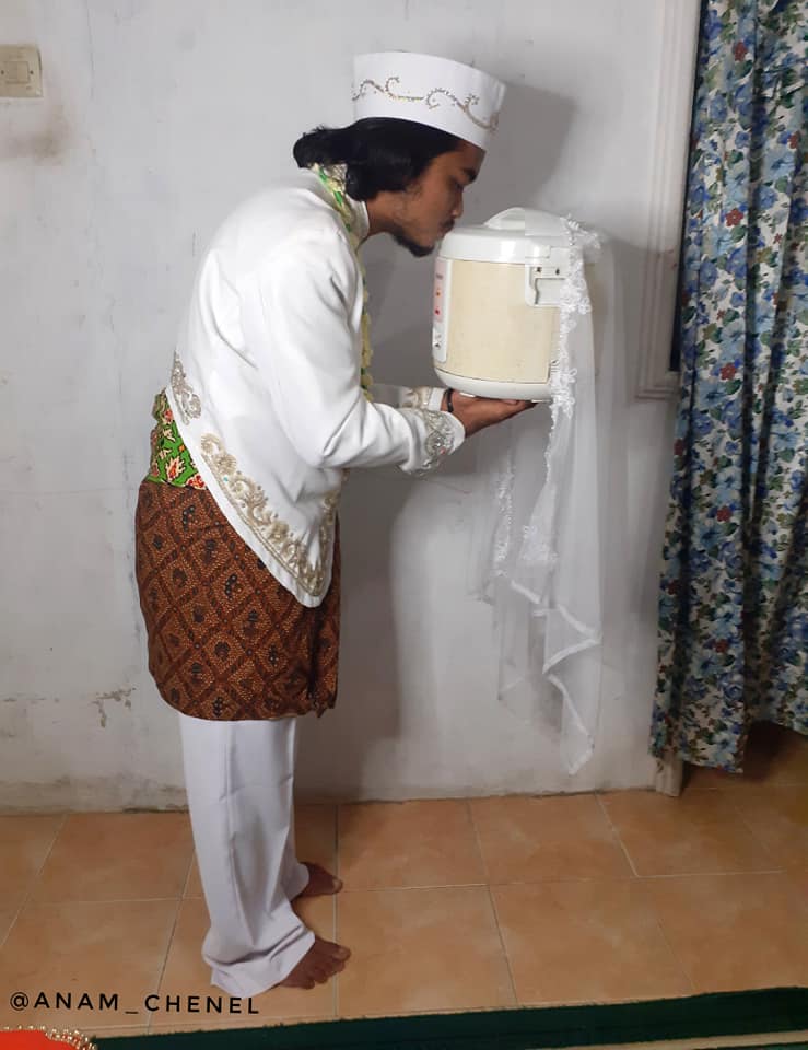 Indonesian Man Kissing A Rice Cooker
