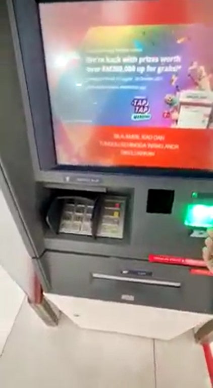 SS1 ATM shoots out malaysia ringgit cash money on the floor