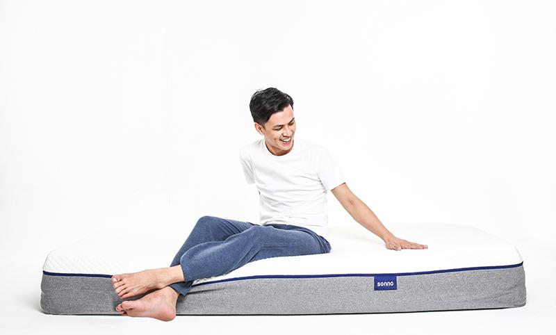 man sitting on Sonno brand bed