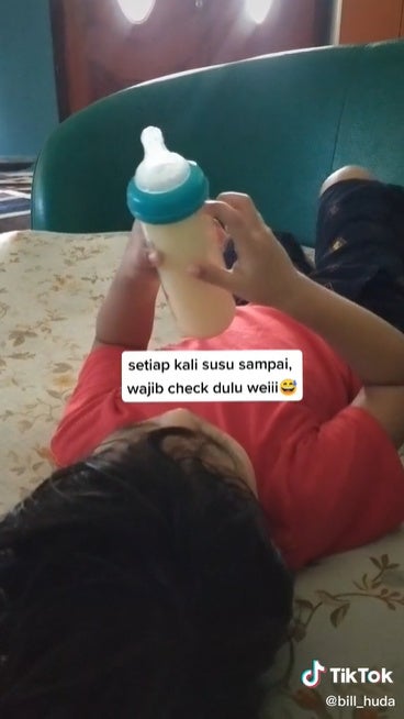 V2 Kid Holding And Checking Full Bottle Of Milk