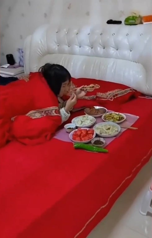 SS 1 woman eating on bed