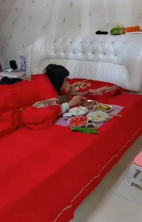 SS 2 woman eating on bed