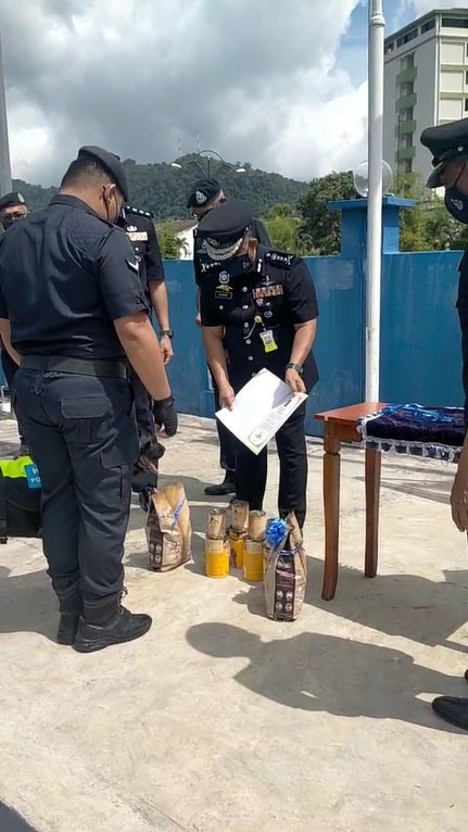 SS8 PDRM Dog Black receiving cans and treats during gratitude ceremony