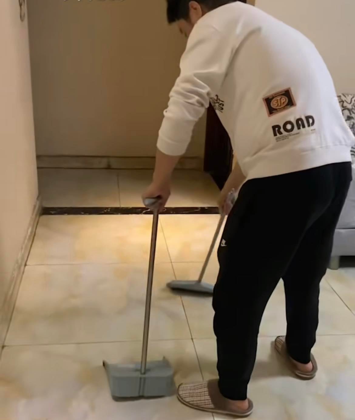 man sweeping floor