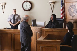 judge listening to lawyer in courtroom