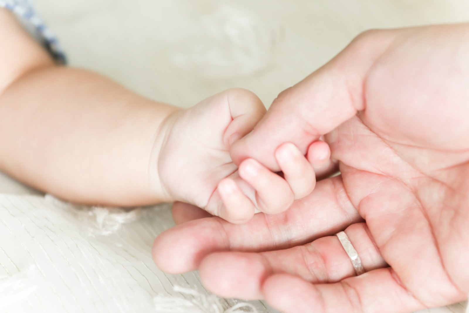 Baby holding mum hand