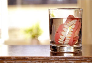 agefoto rm photo of dentures soaking in glass of water