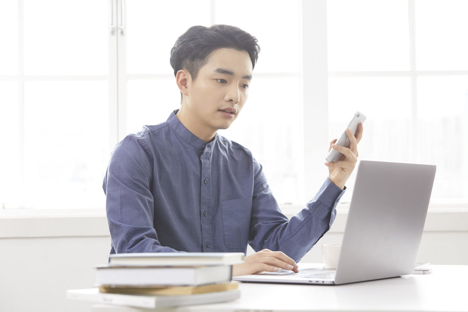 Man Working Holding Phone Laptop