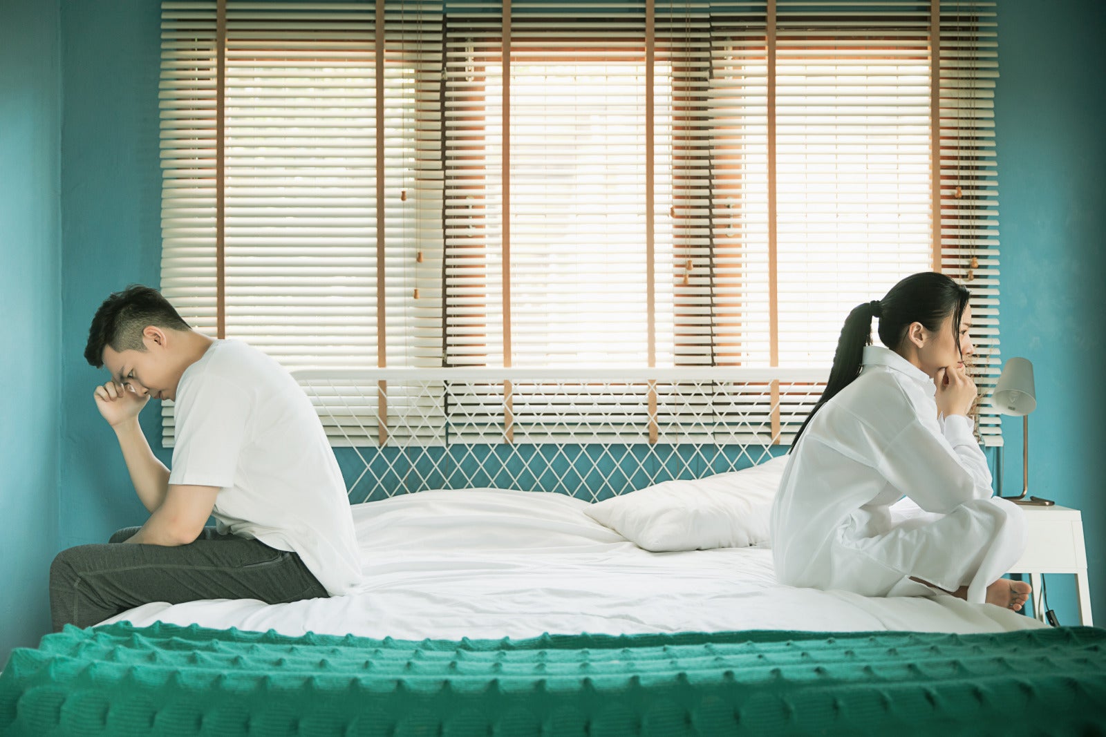 couple quarrel unhappy sitting bedside