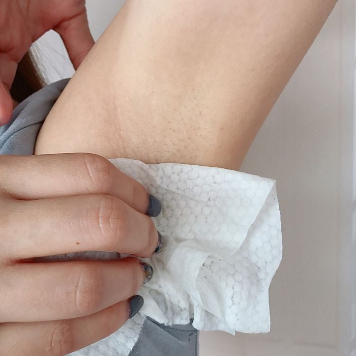 woman wiping armpit tissue