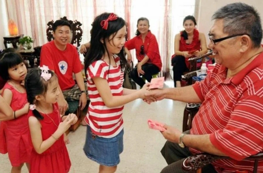 chinese new year family kids take angpow