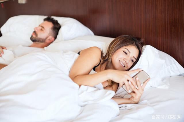 wife cheating phone husband sleeping couple bed