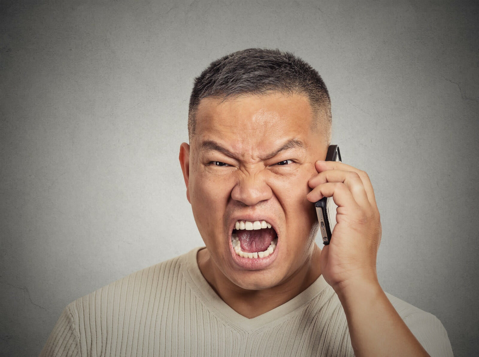 asian man talking on phone pissed angry 123rf