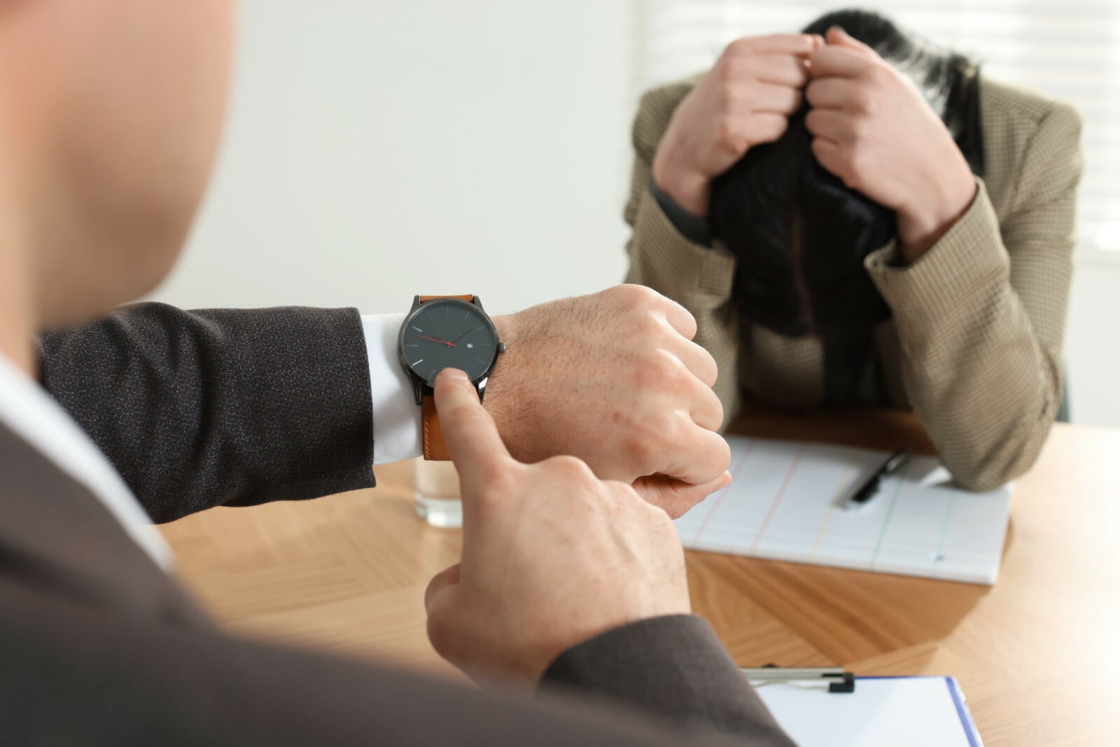 boss pointing watch scold late to work employee 123rf