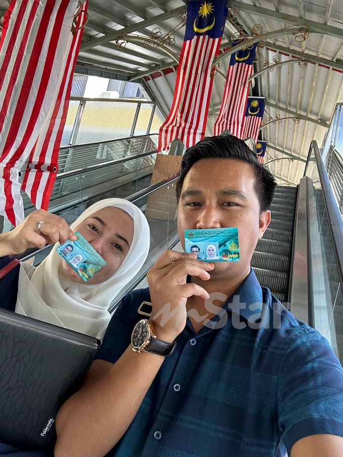 Malay Couple Holding Kad Perakuan Nikah Zaid