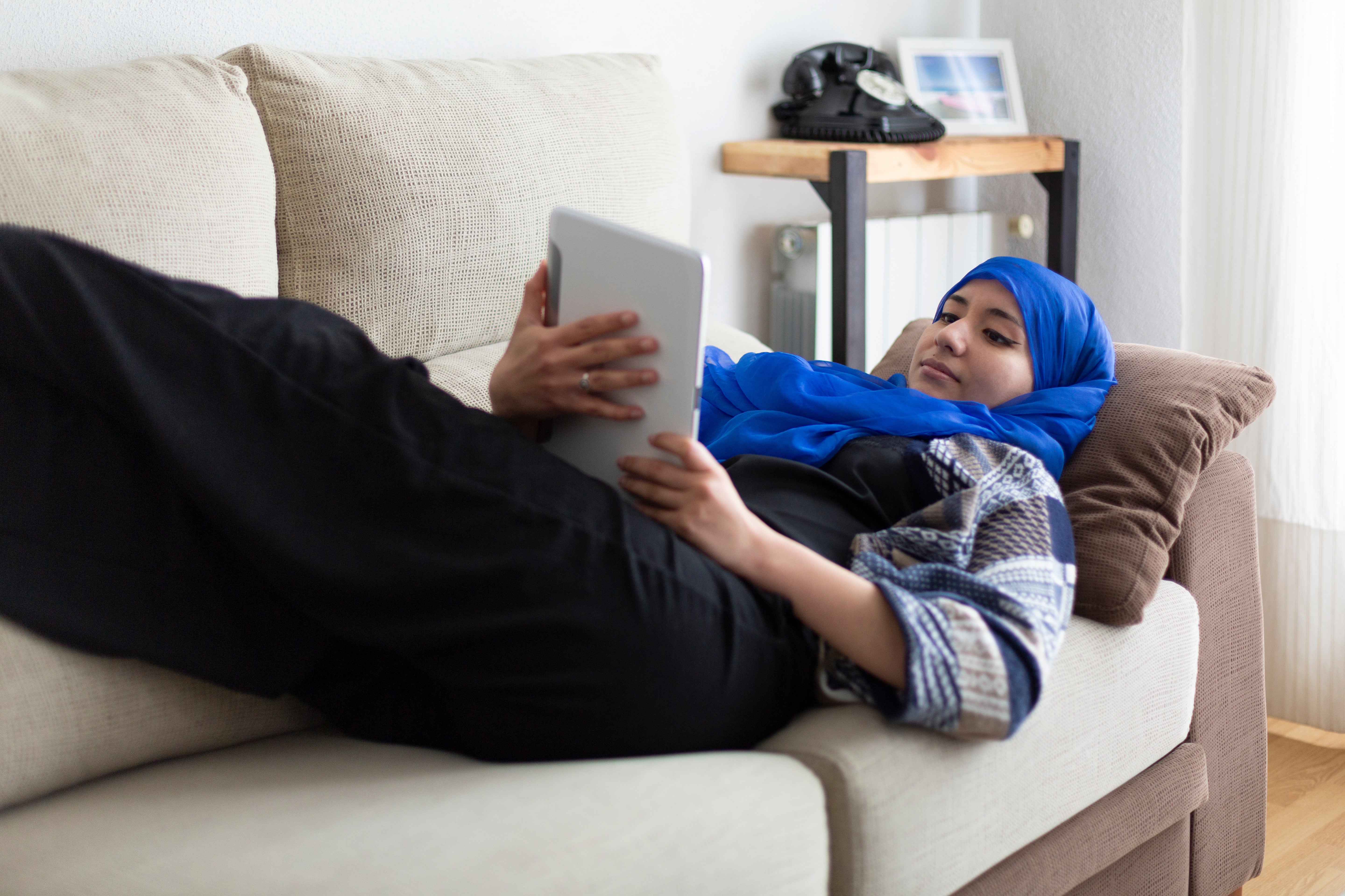 Malay Muslim Hijab Woman Lay On Sofa Relax Ipad