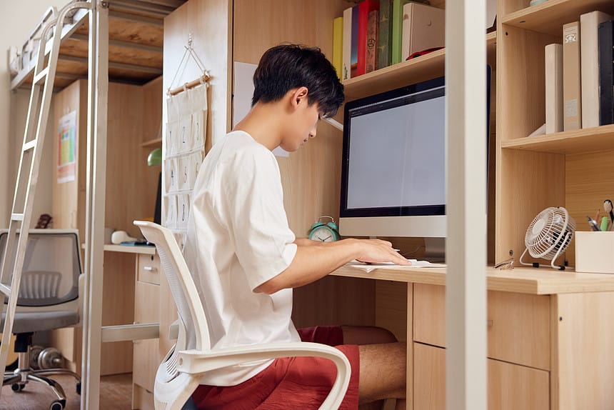 Teenage Young Man Studying Hostel Table