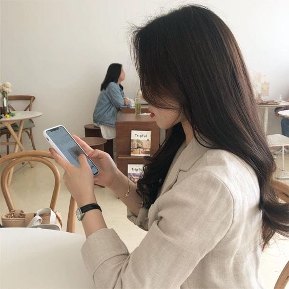 korean ulzzang girl using phone in cafe