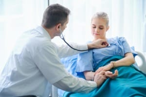 male doctor taking female patient s pulse free photo