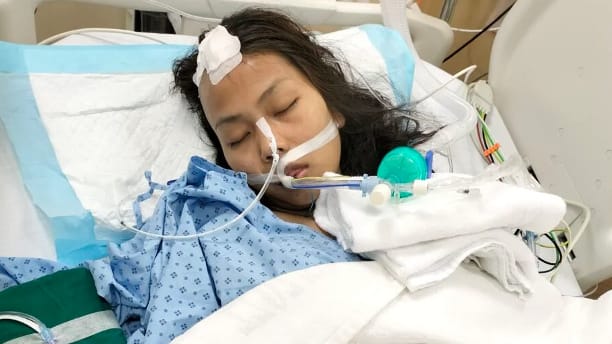maid jomhao laying on hospital bed