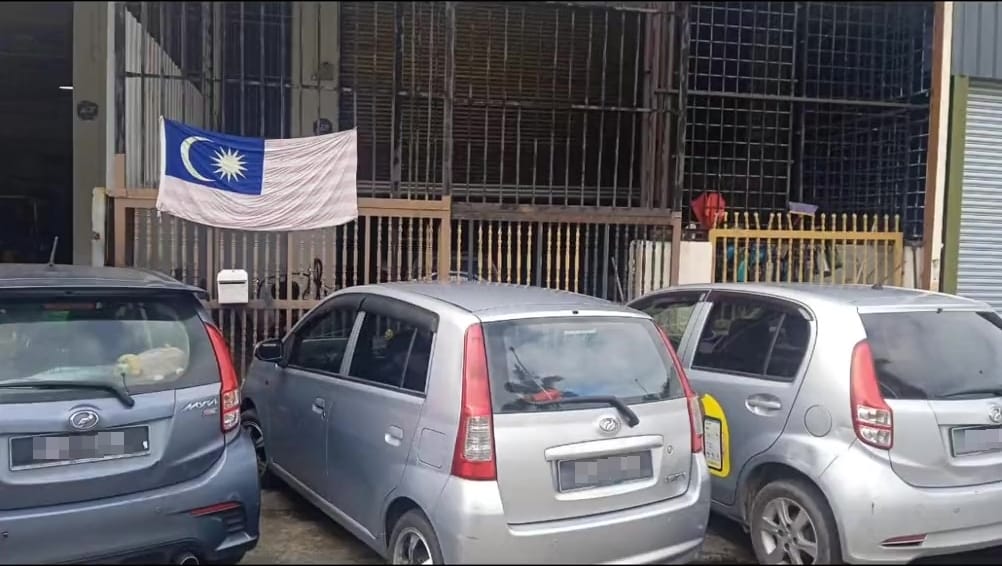 man use forklift to move car parked in front of car repair shop batu caves 1