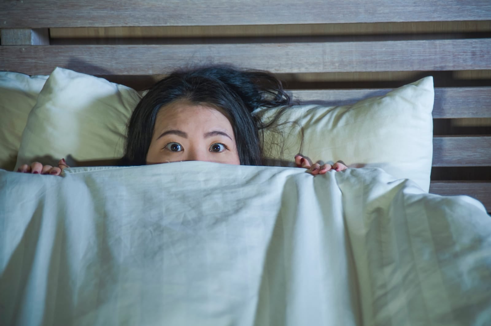 asian woman woke up bed bedroom shocked hides in blanket 123rf