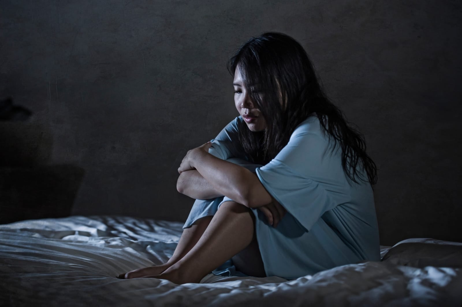 asian young lady depressed sad sitting on bed dark night nightmare 123rf