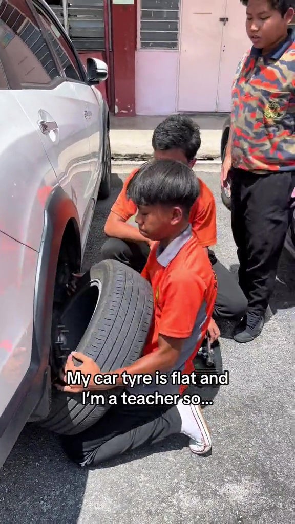 form 2 students help teacher change tyre 13