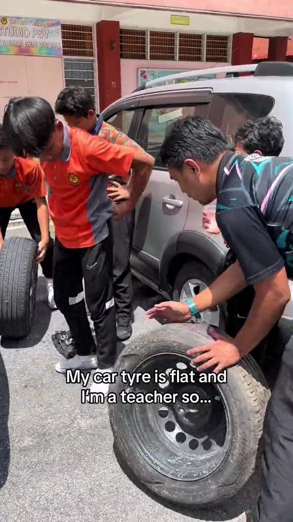 form 2 students help teacher change tyre 14