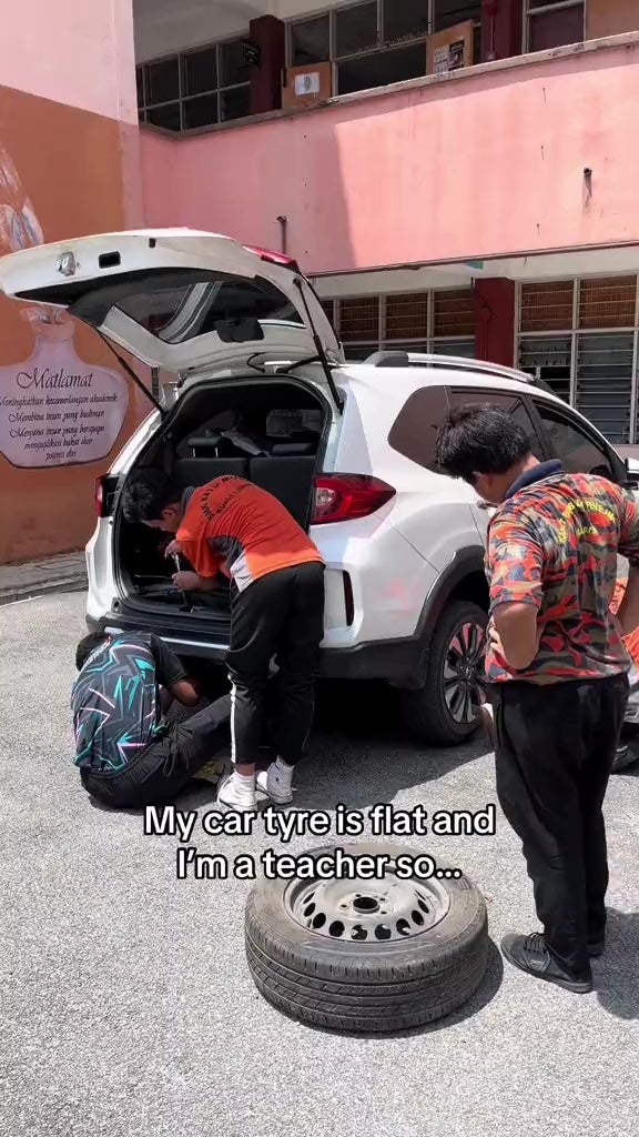 form 2 students help teacher change tyre 2