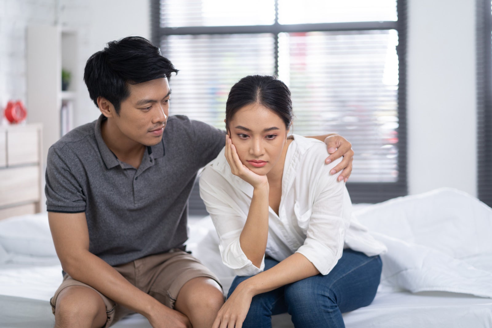 asian husband wife comforting sitting bed home room sad 123rf