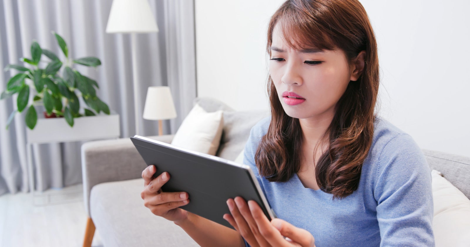 Asian Young Woman Using Tablet Shocked Living Room 123Rf
