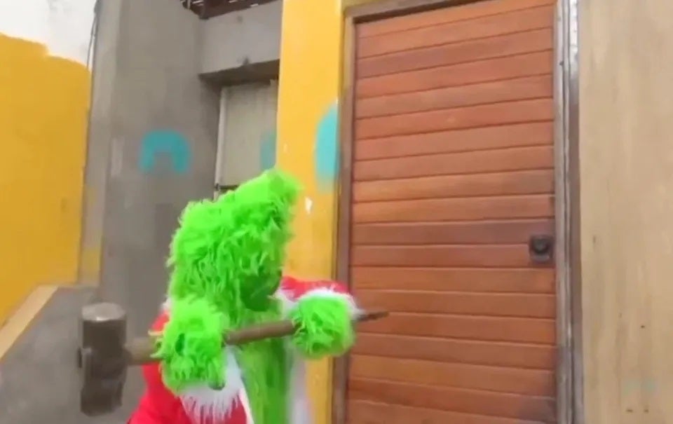 police in grinch costume cosplay raid criminal hammer