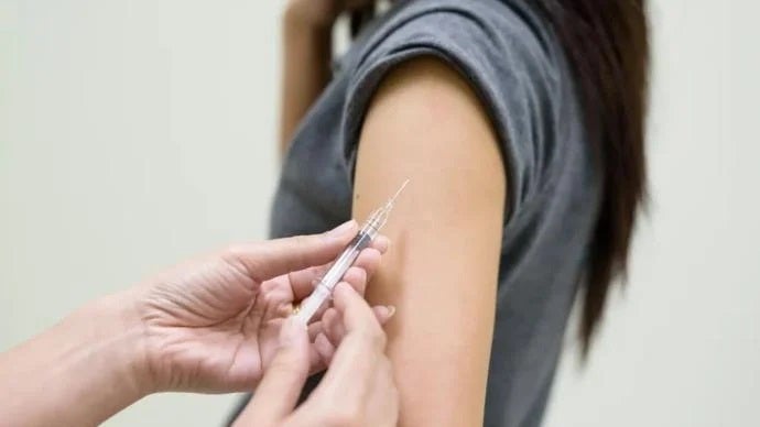 vaccine injection woman arm