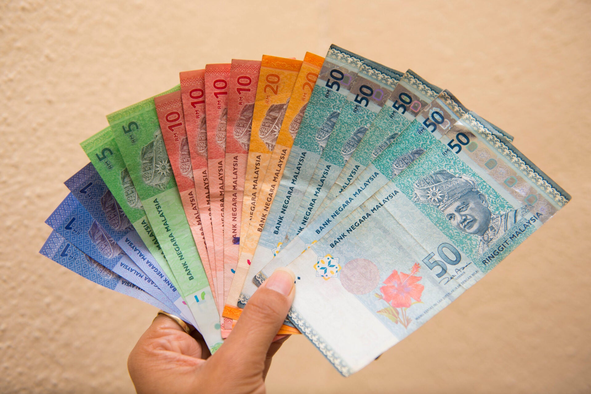 man holding malaysia ringgit banknotes money cash hand 123rf
